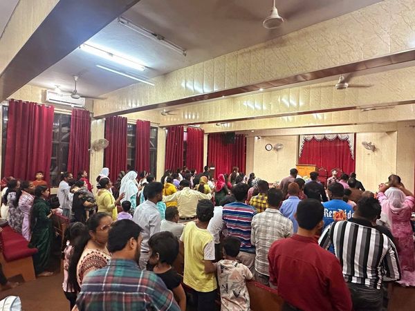 The congregation standing in the Chandigarh hall