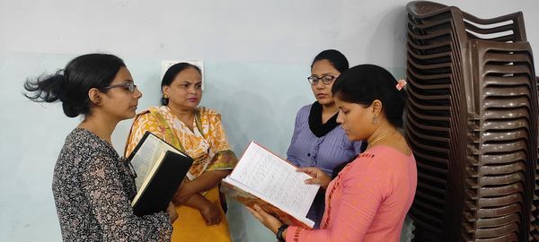 Four women reading their Bibles together