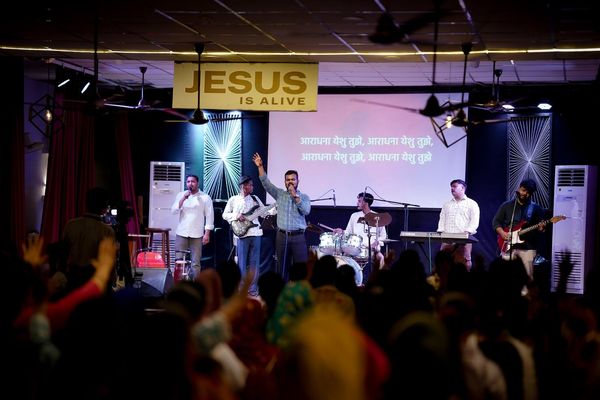 The band playing under the Jesus Is Alive banner