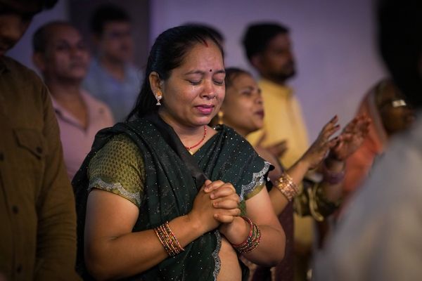 A woman praying with her hands folded