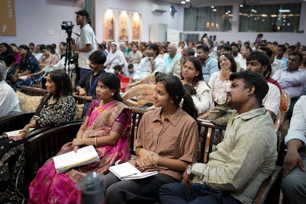 The congregation with open Bibles and notebooks