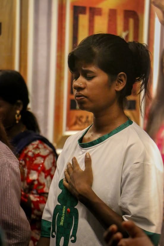 A young woman with her hand on her heart