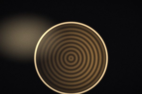 Artwork: a potter’s wheel and wet clay in warm light